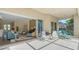 Inviting covered patio featuring lounge chairs and seamless indoor-outdoor living at 7847 Chick Evans Pl, Sarasota, FL 34240