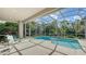 Beautiful pool with lush landscaping, screened in for bug-free enjoyment at 7847 Chick Evans Pl, Sarasota, FL 34240