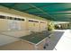 An indoor recreation area offers ping pong near posted pool rules at 7847 Chick Evans Pl, Sarasota, FL 34240