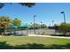 Community tennis courts featuring shade gazebos, and neatly manicured landscaping offer a serene setting for outdoor recreation at 7847 Chick Evans Pl, Sarasota, FL 34240