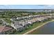 Aerial view of backyard featuring screened in patio and view of lake at 8016 Grande Shores Dr, Sarasota, FL 34240