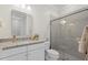 Clean bathroom featuring granite countertops, a glass-enclosed shower, and a neutral color palette at 8016 Grande Shores Dr, Sarasota, FL 34240