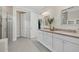 Bathroom featuring double sinks, vanity, modern fixtures, and walk in shower at 8016 Grande Shores Dr, Sarasota, FL 34240