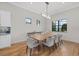 Elegant dining room with modern lighting and view of the water at 8016 Grande Shores Dr, Sarasota, FL 34240