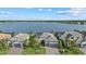 Charming home featuring a well-manicured lawn, lake view, and a two-car garage at 8016 Grande Shores Dr, Sarasota, FL 34240