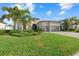 Charming single-story home with a tile roof, arched entry, three-car garage and well-manicured landscaping at 8016 Grande Shores Dr, Sarasota, FL 34240