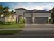 Charming single-story home with a tile roof, arched entry, three-car garage and well-manicured landscaping at 8016 Grande Shores Dr, Sarasota, FL 34240