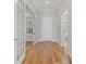 Hallway with hardwood floors and French doors leading to rooms with natural light at 8016 Grande Shores Dr, Sarasota, FL 34240