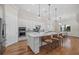 Spacious kitchen with hardwood floors, an island with bar seating, stainless steel appliances and pendant lighting at 8016 Grande Shores Dr, Sarasota, FL 34240