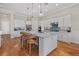 Spacious kitchen featuring white cabinets, stainless steel appliances, backsplash, and a large central island with seating at 8016 Grande Shores Dr, Sarasota, FL 34240
