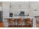 Spacious kitchen island with bar seating, stainless steel appliances and pendant lighting at 8016 Grande Shores Dr, Sarasota, FL 34240