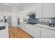 Modern kitchen with white cabinets, stainless steel appliances, granite countertops, and a stylish backsplash at 8016 Grande Shores Dr, Sarasota, FL 34240