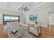Bright living room with coffered ceiling, large windows with water view, and neutral-toned furniture at 8016 Grande Shores Dr, Sarasota, FL 34240
