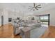 Open-concept living space featuring a large sofa, stylish furniture, and a seamless flow into the kitchen at 8016 Grande Shores Dr, Sarasota, FL 34240