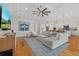Spacious living room with a large TV, modern decor, and seamless flow into kitchen at 8016 Grande Shores Dr, Sarasota, FL 34240