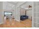 Open-concept living space with hardwood floors and views into a cozy den with a built-in murphy bed at 8016 Grande Shores Dr, Sarasota, FL 34240