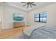 Light-filled bedroom with a large window and television, creating a cozy atmosphere at 8016 Grande Shores Dr, Sarasota, FL 34240