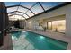 Relaxing outdoor kitchen with a covered lanai, featuring a pool and outdoor lounge area at 8016 Grande Shores Dr, Sarasota, FL 34240