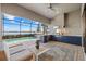 An expansive screened lanai featuring a full outdoor kitchen and a pool overlooking the lake at 8016 Grande Shores Dr, Sarasota, FL 34240