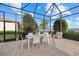 Covered patio boasts serene lake views, dining area and plenty of room for entertaining at 8016 Grande Shores Dr, Sarasota, FL 34240
