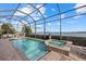 Sparkling screened in pool and hot tub overlooking a tranquil lake at 8016 Grande Shores Dr, Sarasota, FL 34240