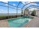 Screened-in pool and spa offer a relaxing outdoor space with beautiful lake views at 8016 Grande Shores Dr, Sarasota, FL 34240