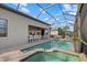 Relaxing screened-in pool area with spa, wet bar and lots of room for entertaining at 8016 Grande Shores Dr, Sarasota, FL 34240