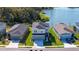 Aerial view of gray two-story home situated near a tranquil pond at 8918 Waxwing Way, Parrish, FL 34219