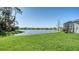 Backyard featuring a tranquil pond view and a well-maintained lawn at 8918 Waxwing Way, Parrish, FL 34219
