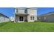 Backyard with a covered patio, lush green lawn, and ample space for activities at 8918 Waxwing Way, Parrish, FL 34219