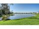Expansive backyard overlooking a serene pond, surrounded by lush greenery at 8918 Waxwing Way, Parrish, FL 34219