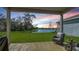 Enjoy peaceful lake views from this backyard patio with cozy seating at sunset at 8918 Waxwing Way, Parrish, FL 34219