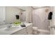 Stylish bathroom featuring a double vanity with modern fixtures and a shower-tub combo, offering comfort and convenience at 8918 Waxwing Way, Parrish, FL 34219