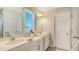 Bright bathroom features a double vanity with quartz countertops and modern fixtures, providing ample space at 8918 Waxwing Way, Parrish, FL 34219