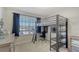 Functional bedroom features a loft bed with built-in desk and storage, providing a versatile space for work and rest at 8918 Waxwing Way, Parrish, FL 34219