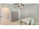 Bedroom featuring a ceiling fan, closet door, and a gray dresser with drawers at 8918 Waxwing Way, Parrish, FL 34219
