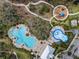 Aerial view of the community pool, splash pad, playground and walking paths at the Summerwoods neighborhood at 8918 Waxwing Way, Parrish, FL 34219