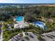 Aerial view of the Summerwoods community pool with a large pool, splashpad, palm trees, and plenty of parking at 8918 Waxwing Way, Parrish, FL 34219