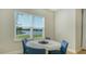 Cozy dining area with lake view, natural light, and contemporary decor creates an inviting atmosphere at 8918 Waxwing Way, Parrish, FL 34219