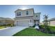 Beautifully landscaped two-story home with attached garage and inviting entryway during the day at 8918 Waxwing Way, Parrish, FL 34219