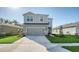 Two-story home featuring a spacious driveway and well-manicured lawn at 8918 Waxwing Way, Parrish, FL 34219