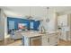 Open-concept kitchen and living room with an island and stainless steel appliances that create a seamless flow at 8918 Waxwing Way, Parrish, FL 34219