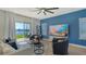 Bright living room with lake view, modern decor, and sliding glass doors to the patio at 8918 Waxwing Way, Parrish, FL 34219