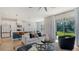 Bright, open living space with contemporary furnishings, an island kitchen, and access to the outdoors at 8918 Waxwing Way, Parrish, FL 34219