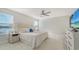 Bright main bedroom features a king bed, serene water view, and abundant natural light through the windows at 8918 Waxwing Way, Parrish, FL 34219