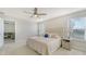Inviting main bedroom with a comfortable king bed, ceiling fan, and sunny windows with bright natural light at 8918 Waxwing Way, Parrish, FL 34219