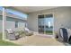 Covered patio with comfortable seating and a view of the serene lake at 8918 Waxwing Way, Parrish, FL 34219