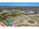 An aerial view of the neighborhood highlighting the community pool, clubhouse, tennis courts, and proximity to surrounding lakes at 10165 Canaveral Cir, Sarasota, FL 34241