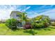 Landscaped backyard with a private pool, patio, and tropical plants providing a tranquil outdoor living space at 10165 Canaveral Cir, Sarasota, FL 34241