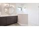 Modern bathroom features a frameless shower, large vanity, and updated fixtures at 10165 Canaveral Cir, Sarasota, FL 34241